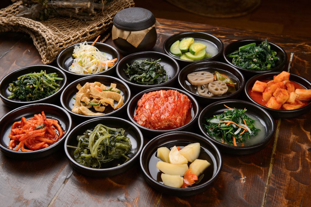 Các đĩa banchan nhỏ xinh bày biện trên bàn ăn ẩm thực Hàn Quốc