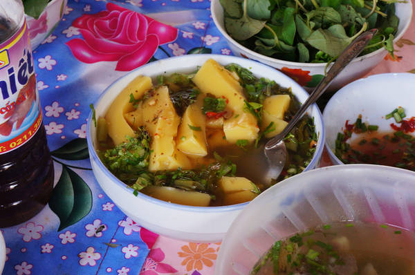 Ngoài mèn mén, du khách có thể tìm thấy bánh đúc ngô được đặt trong chậu lớn, cắt từng miếng khi có khách. Giá 10.000 đồng một bát. Ảnh Vnexpress
