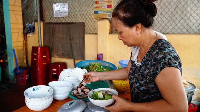 Không gian quán nằm gọn trong khoảng sân chừng 15 mét vuông ở trước sân nhà. Gian bếp đặt phía trước là nơi chế biến món ăn mang ra cho khách.