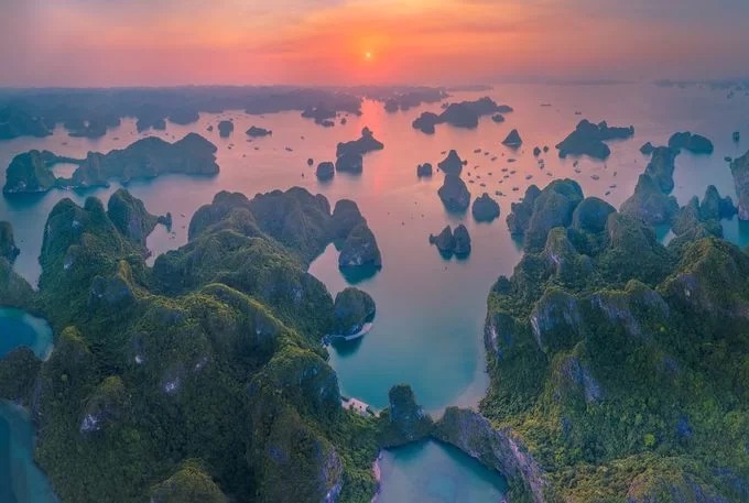 Vịnh Hạ Long lúc hoàng hôn. Mặt vịnh lúc này được nhuộm sắc đỏ rực của những tia nắng cuối cùng.